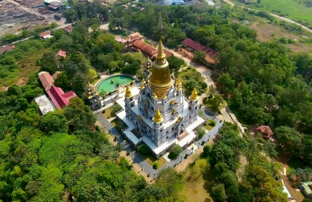 The pagoda grounds are spacious, covered by cool green canopies, creating a pure and peaceful space